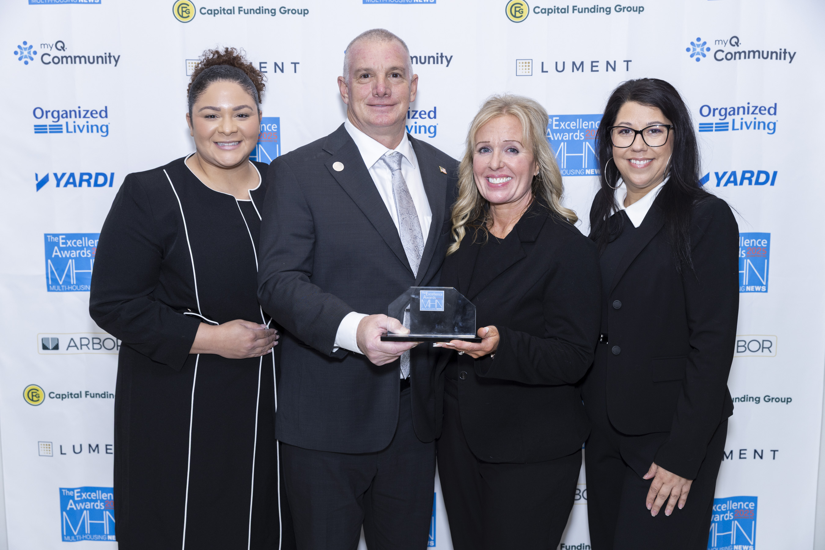 Group photo of Liberty Military Housing. Gary Dikes, Ocotillo Heights received Gold as Facilities & Maintenance Manager of the Year. Katie Dirkx was Property Manager of the Year, Gold for her work at Joint Base Lewis-McChord. Image by Gary Spector