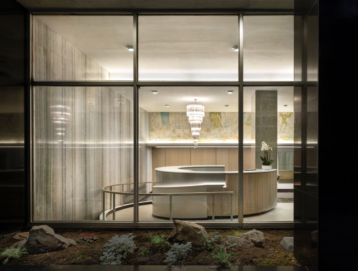 PJCArchitecture combined preserved marble walls and terrazzo floors with an integrated ADA ramp and curved reception for a low-maintenance, “quiet luxury” upgrade.