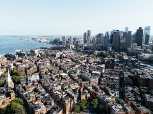 Aerial view of Boston city, bridges and river with skyline in sunlight. g.