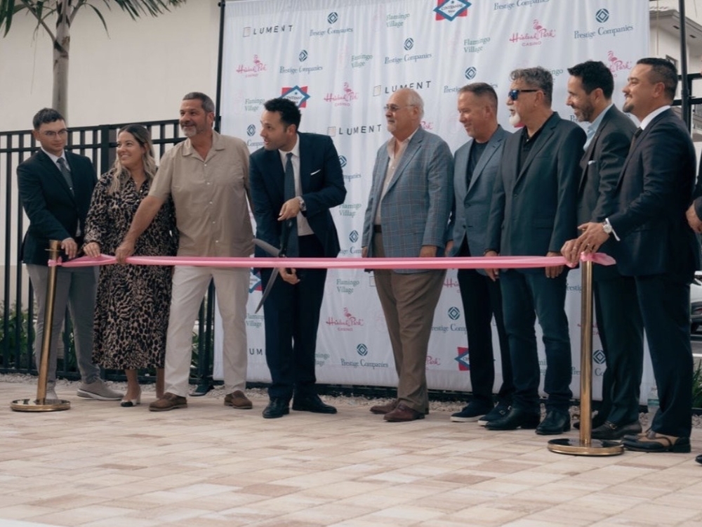 Prestige Cos., Brunetti Organization and Centennial Bank representatives celebrating the opening of Flamingo Village.