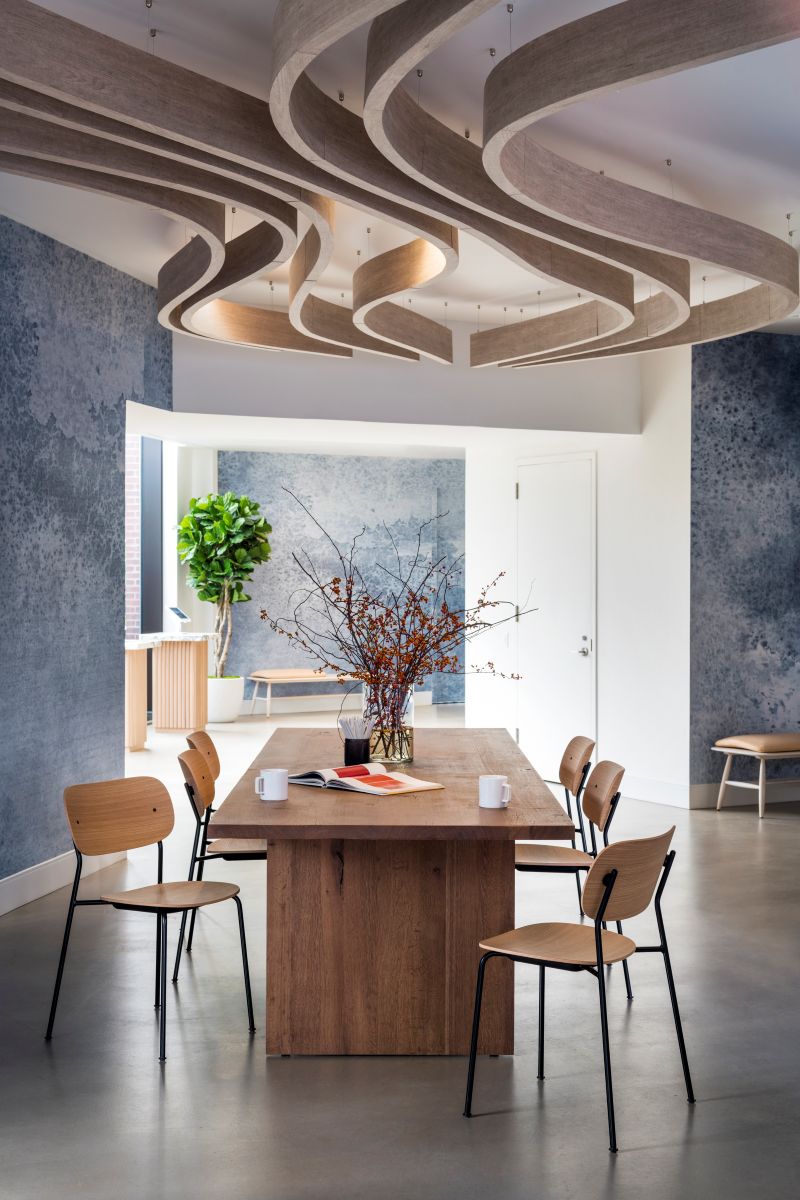 Sculpted ceiling baffles control acoustics while wood, laminate and concrete finishes keep maintenance low in the high-use lounge designed by Mazzarini & Co.