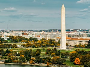 Aerial establishing shot of Washington, D.C. on a sunny day in Fall from over the Tidal Basin.