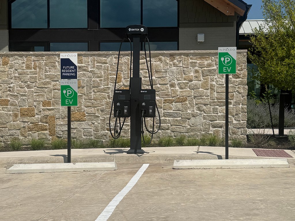 A photograph of an EV charging station, installed at a multifamily community in Texas, which will allow future residents to charge their electric cars on site.