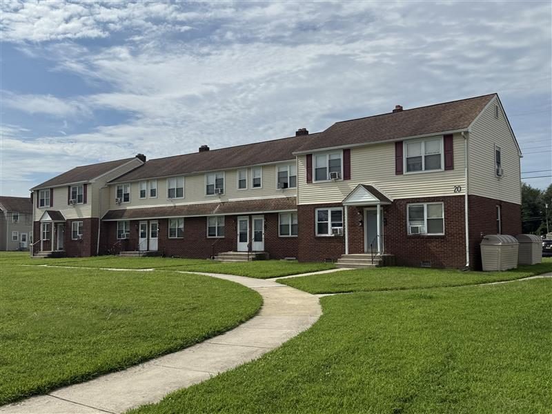 Exterior shot of several buildings part of Paulsboro Gardens Apartments, courtesy of People Restoring Communities