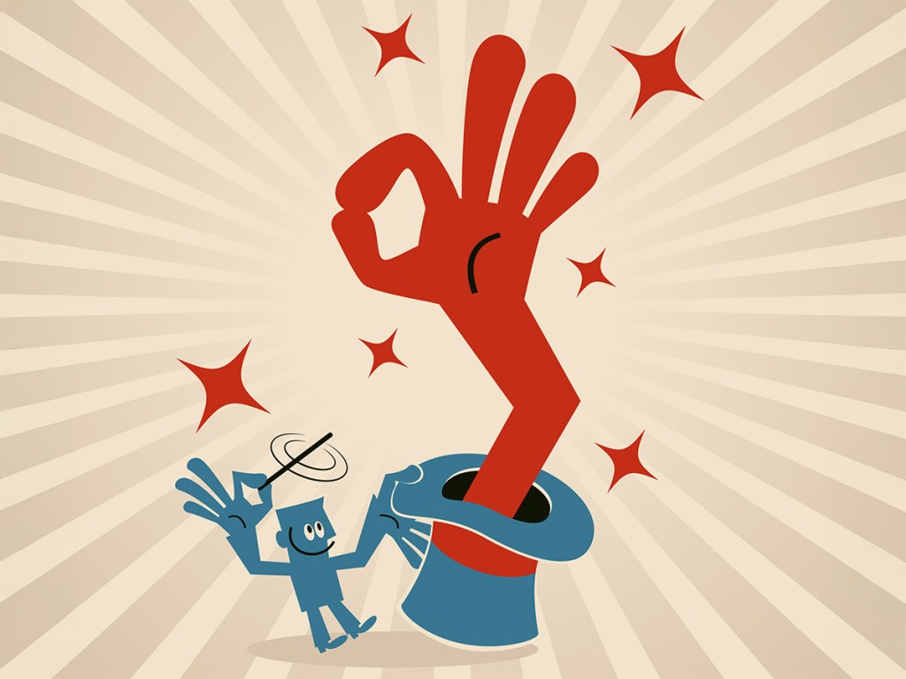 Businessman waving magic wand and then a big hand coming out of magic hat and showing ok hand sign