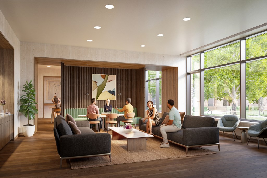 people chatting in the bright coworking lounge of Willets Point redevelopment in Queens