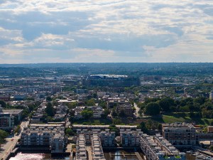 An aerial view of Baltimore skyline with waterfront apartments and cityscape under bright clouds, USA