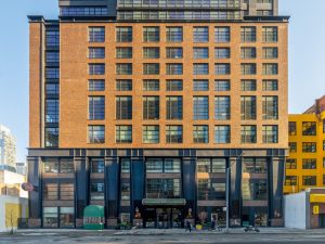 photo of Henry Hall, a 33-story, 225-unit luxury multifamily tower at 525 W. 38th St. in the Hudson Yards neighborhood in Manhattan. Amstar Group LLC of Denver acquired the property from a Shorenstein Investment Advisors and Dreamscape Cos. joint venture.