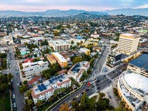 Aerial panorama shows downtown Los Angeles skyline at sunset over California