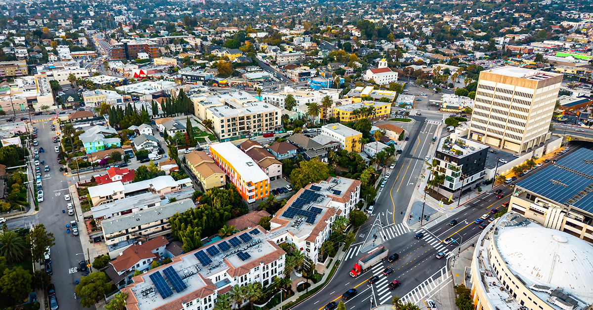 Aerial panorama shows downtown Los Angeles skyline at sunset over California
