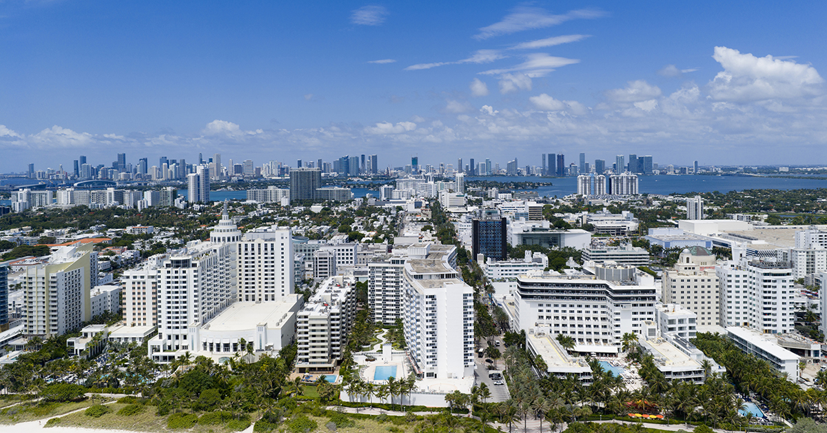 Miami beach with turquoise waters. Aerial view of sandy coastline and waves. Tropical Miami Beach scene with sandy beach. Oceanfront of South Miami. Panoramic of Miami Beach