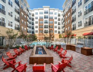 red chairs around an area by the pool