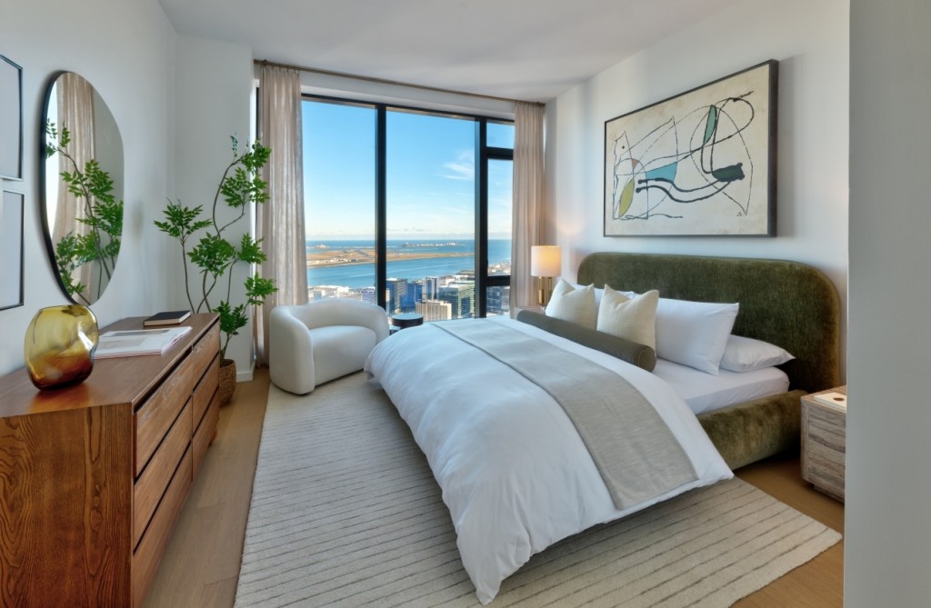Modern bedroom with a large bed, abstract art.