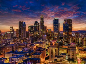 Exterior shot featuring Los Angeles' skyline at sunset.