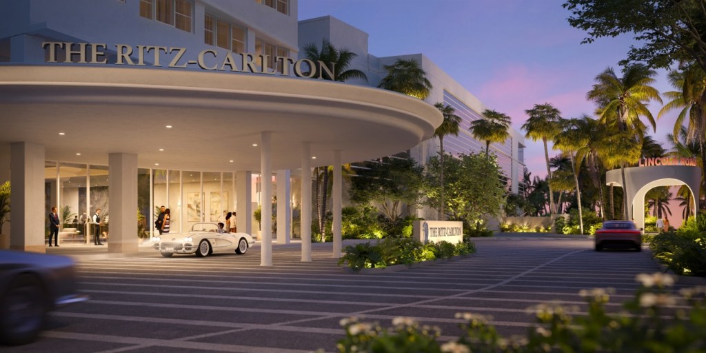 Luxury hotel entrance at dusk, featuring The Ritz-Carlton sign. A white car and a red car parked under a lit portico. Palm trees and greenery line the driveway.