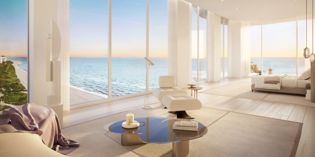 Luxurious oceanfront living room with floor-to-ceiling windows, modern furniture, and a stunning ocean view. Bright, airy, and serene atmosphere.