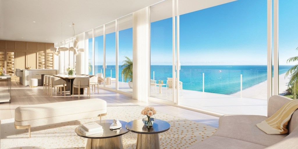 Luxurious oceanfront living room with floor-to-ceiling windows, modern furniture, and a stunning ocean view. Bright, airy, and serene atmosphere.