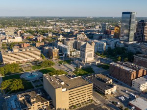 Indianapolis, United States – October 06, 2025: Wide aerial view of the Indiana World War Memorial Plaza with surrounding downtown Indianapolis buildings and cityscape.