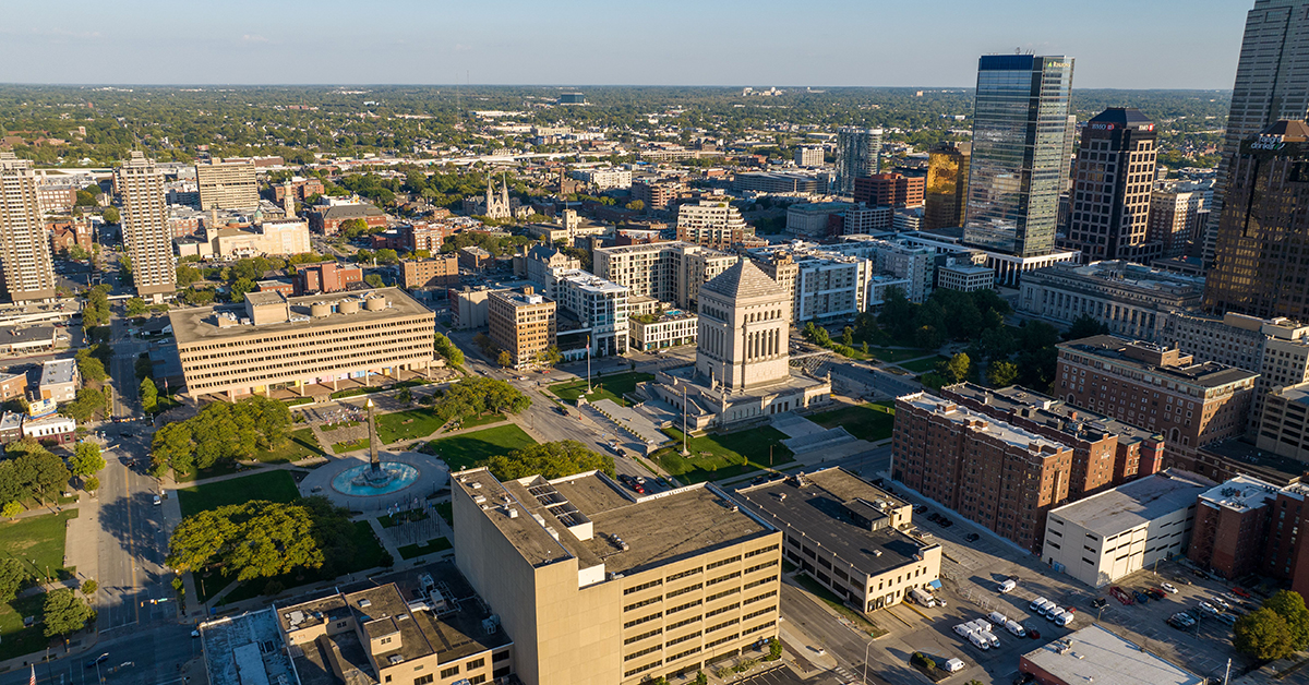 Indianapolis, United States – October 06, 2025: Wide aerial view of the Indiana World War Memorial Plaza with surrounding downtown Indianapolis buildings and cityscape.