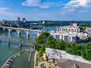 Drone angle view of Knoxville skyline, bridges, and Tennessee River.