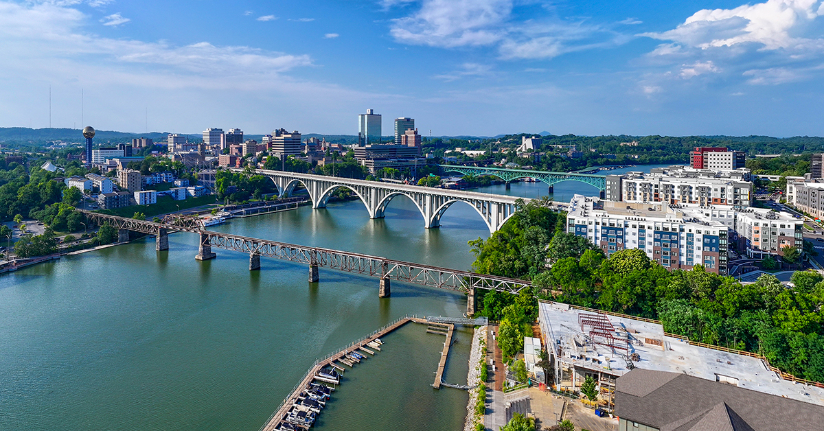 Drone angle view of Knoxville skyline, bridges, and Tennessee River.