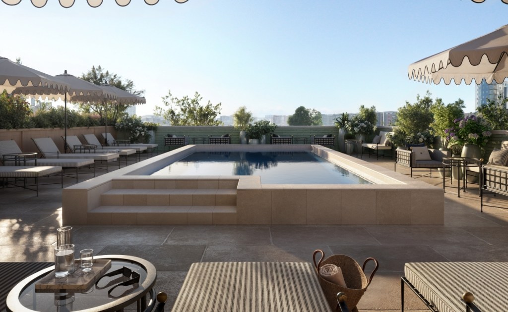 Rooftop pool at sunrise with lounge chairs and umbrellas. Surrounding greenery adds a serene vibe. Elegant, relaxed atmosphere with light reflections on water.