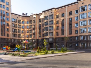 Exterior shot of a multifamily property with a playground.