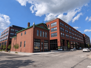 A photo of Albion Lawrenceville, a six-story, 267-unit luxury multifamily property that includes the restoration of a former firehouse for use as retail space.