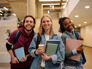 Multiracial group of happy college friends looking at camera.