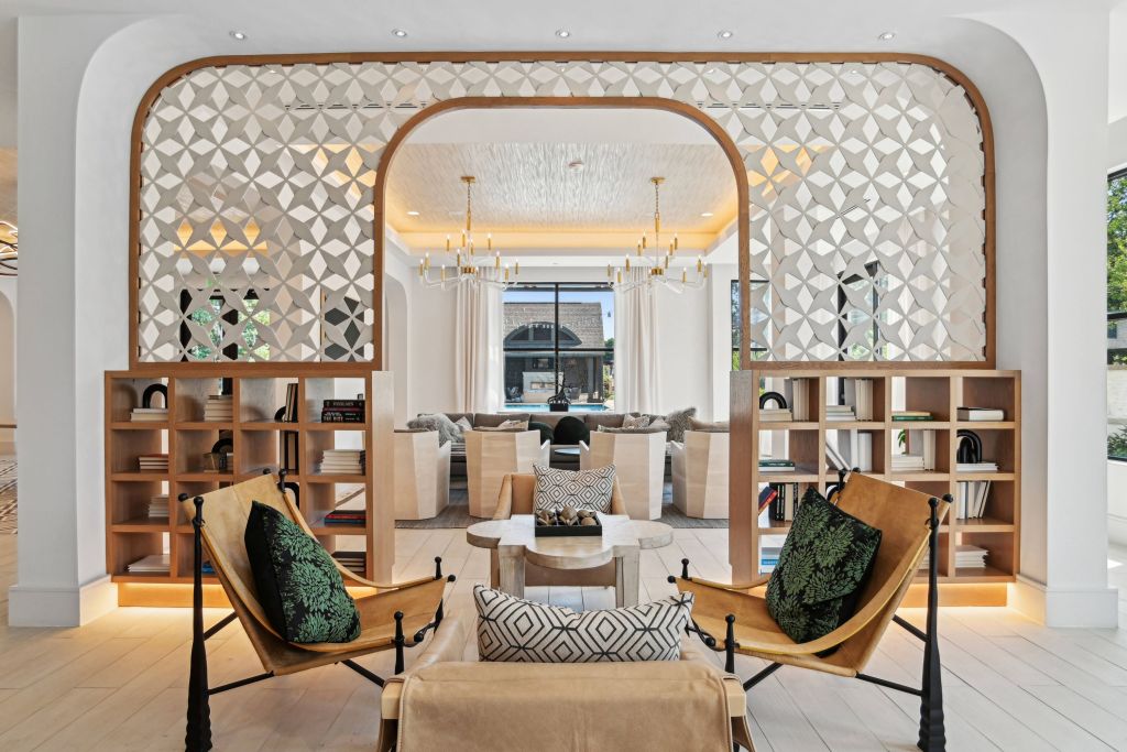 Bright lobby and seating area at Benson Ballantyne framed by decorative archways and shelving. For Evolution of Multifamily Marketing article.