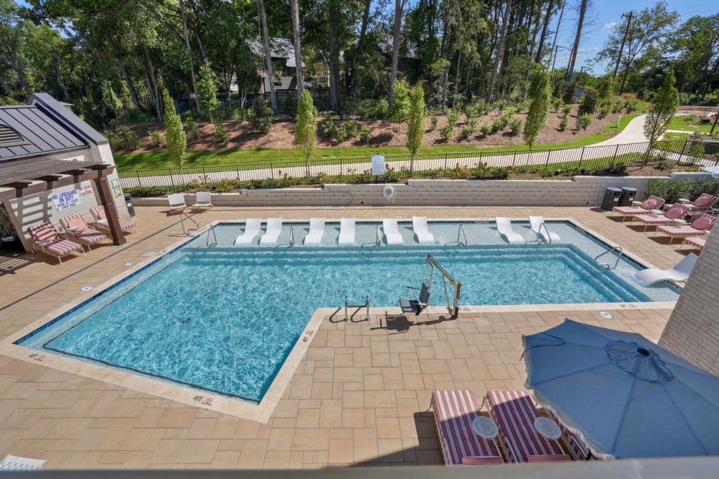 Outdoor pool and lounge deck at NOVEL Davidson viewed from above.