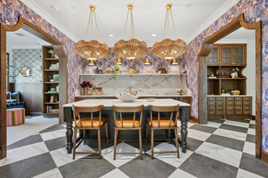 Patterned kitchen and clubroom interior at NOVEL Davidson with island seating and decorative lighting.