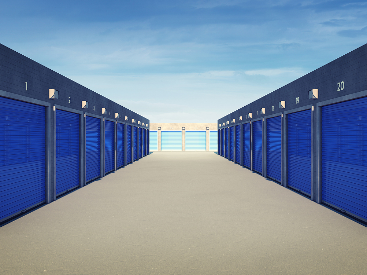 Outdoor self storage units with blue doors.