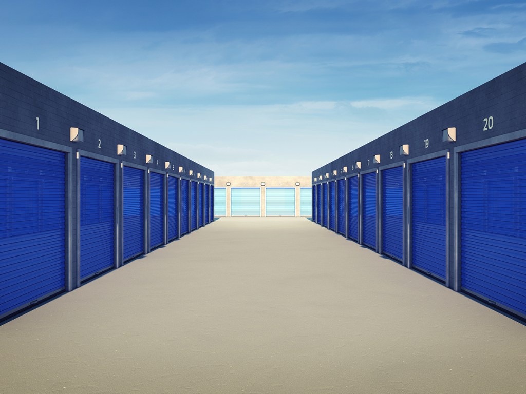 Outdoor self storage units with blue doors.