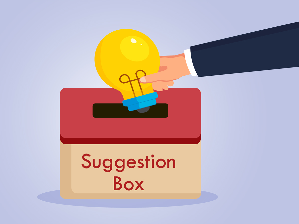 Hand putting a light bulb into a suggestion box