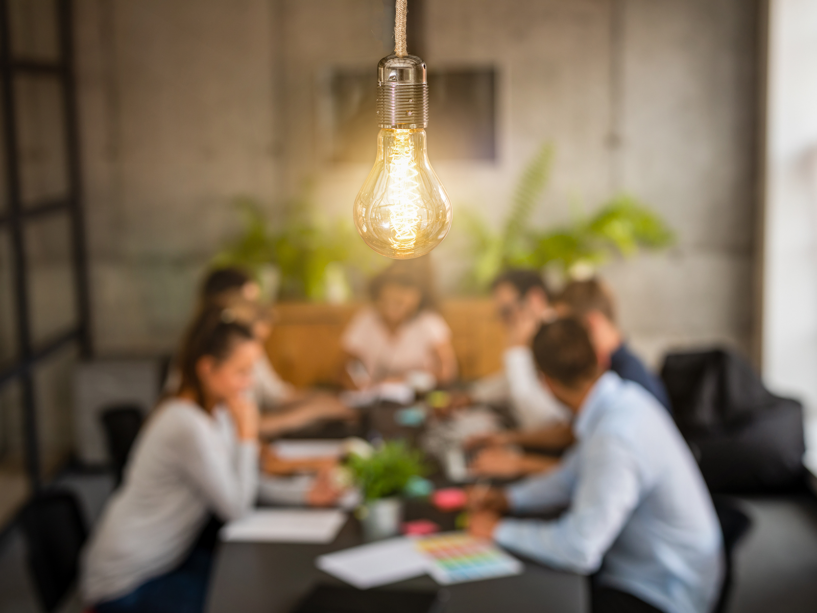 Picture of people in a meeting sitting at a table.