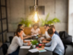 Picture of people in a meeting sitting at a table.