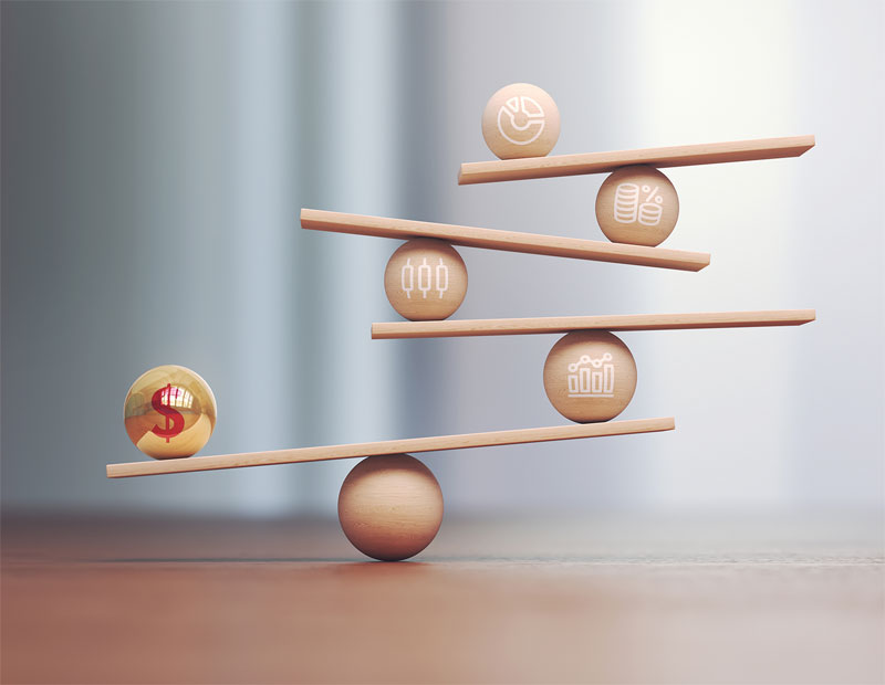 Yellow Red Metal Ball Dollar Symbol on Wooden Libra Scale and Wooden Financial Charts Depth Of Field