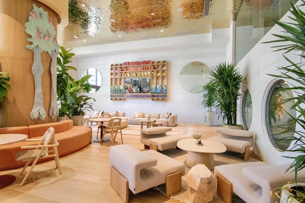 lobby featuring red couches and decorative plants