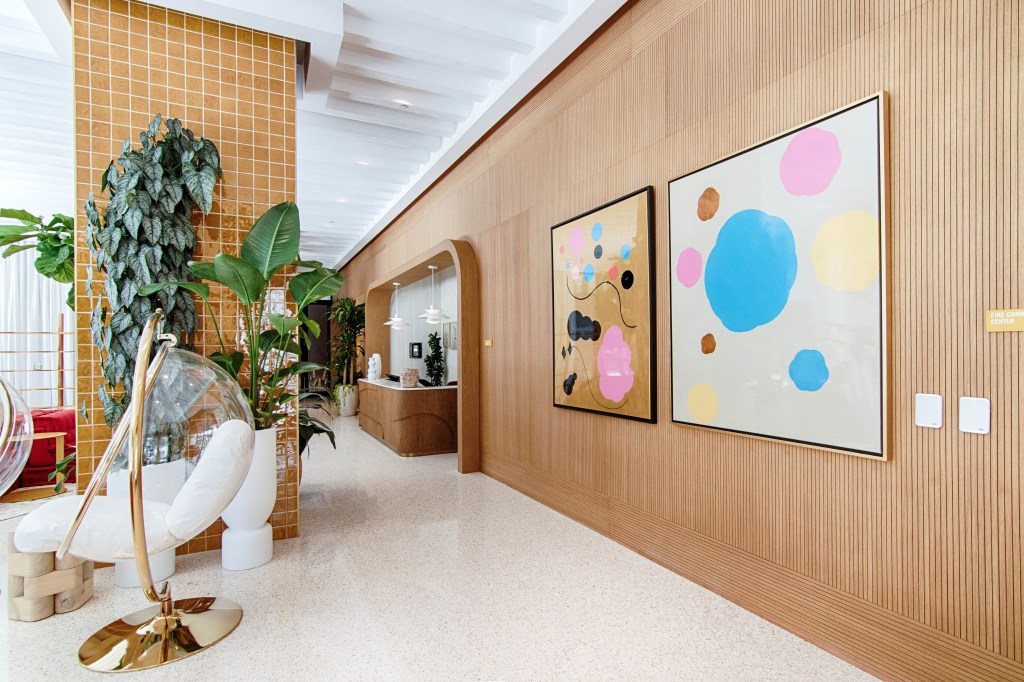 lobby with plants and colorful artwork on walls