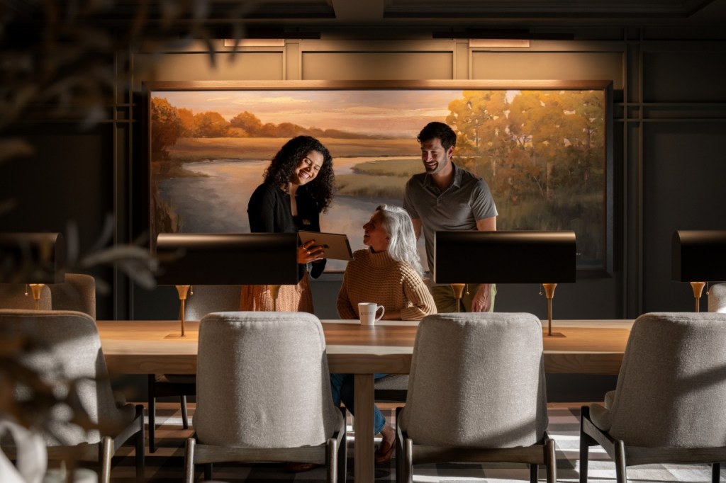 couple talking with a painting behind them