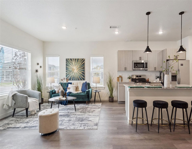 The kitchen and living room area at a unit at The Villas at Ridgeline Vista in Brighton, Colo.