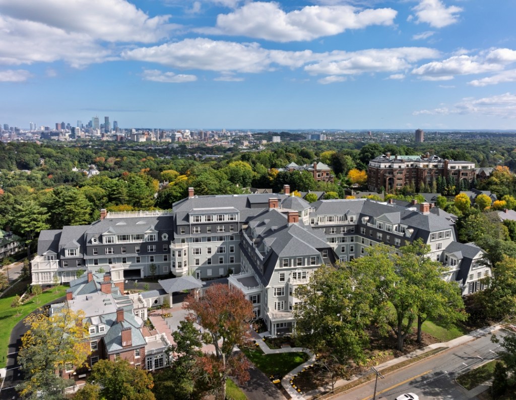 Aerial view of the Newbury at Brookline, showcasing its buildings, green spaces, and pathways.