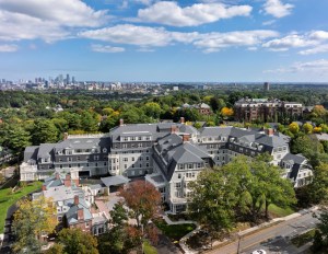 Aerial view of the Newbury at Brookline, showcasing its buildings, green spaces, and pathways.