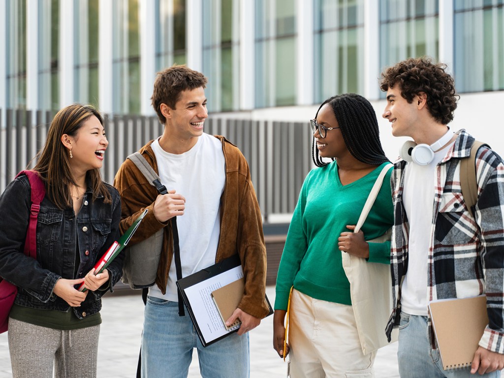 Happy university student friends together in the College campus. Diversity in global education